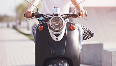 Girl hipster sitting on a black retro scooter