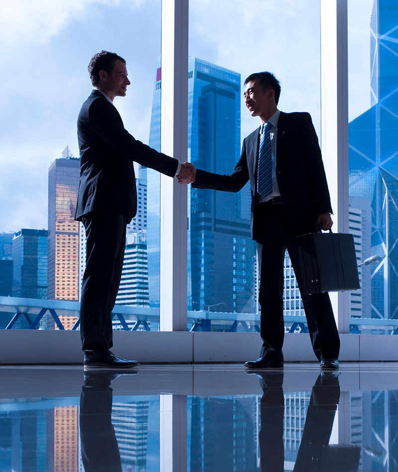 Two businessmen shaking hands in an office
